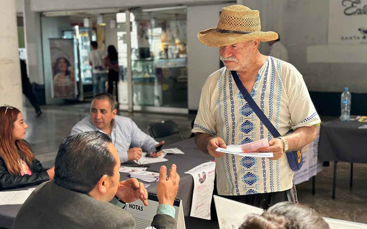 Módulo de atención para búsqueda de empleo en Toluca, atendiendo una persona mayor interesada